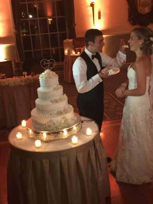 Brooklyn Wedding Reception Groom feeds Bride Wedding Cake