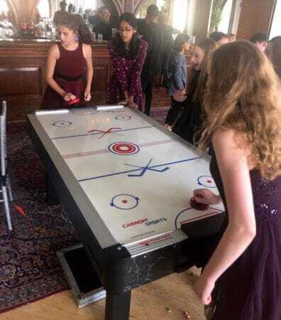 New York City loft bat mitzvah Bat Mitzvah guests playing Air Hockey