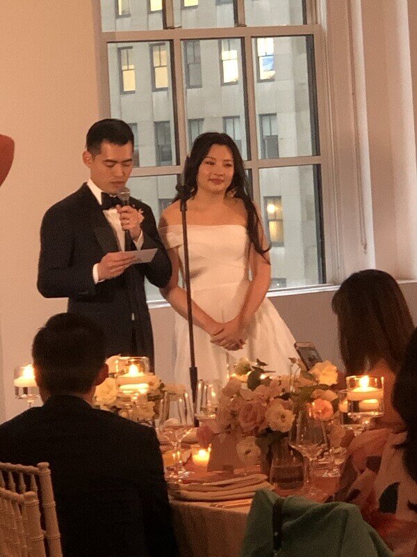 Wedding dinner speech by Groom with Bride closeby Bride and Groom toast at Wedding