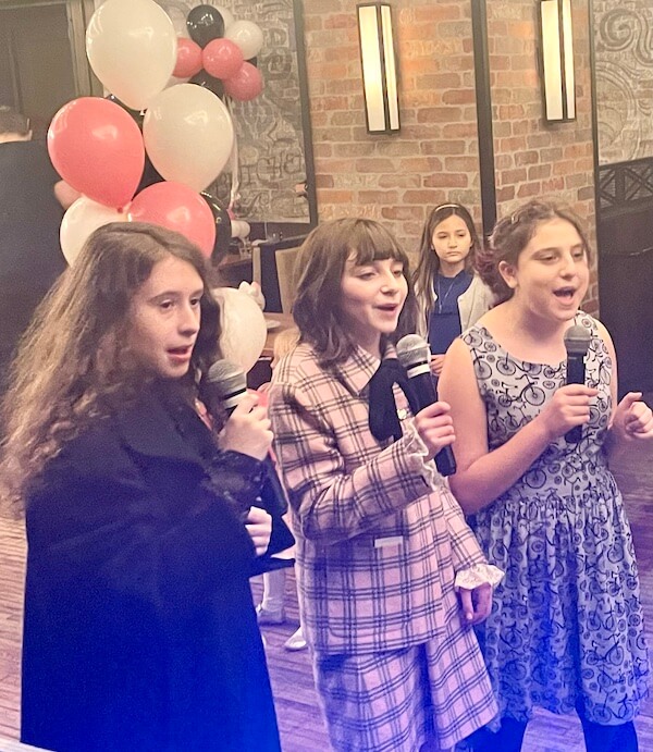 Bat Mitzvah girl and friends sing karaoke